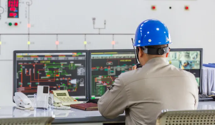 Operations leader reviewing performance dashboard on a manufacturing floor